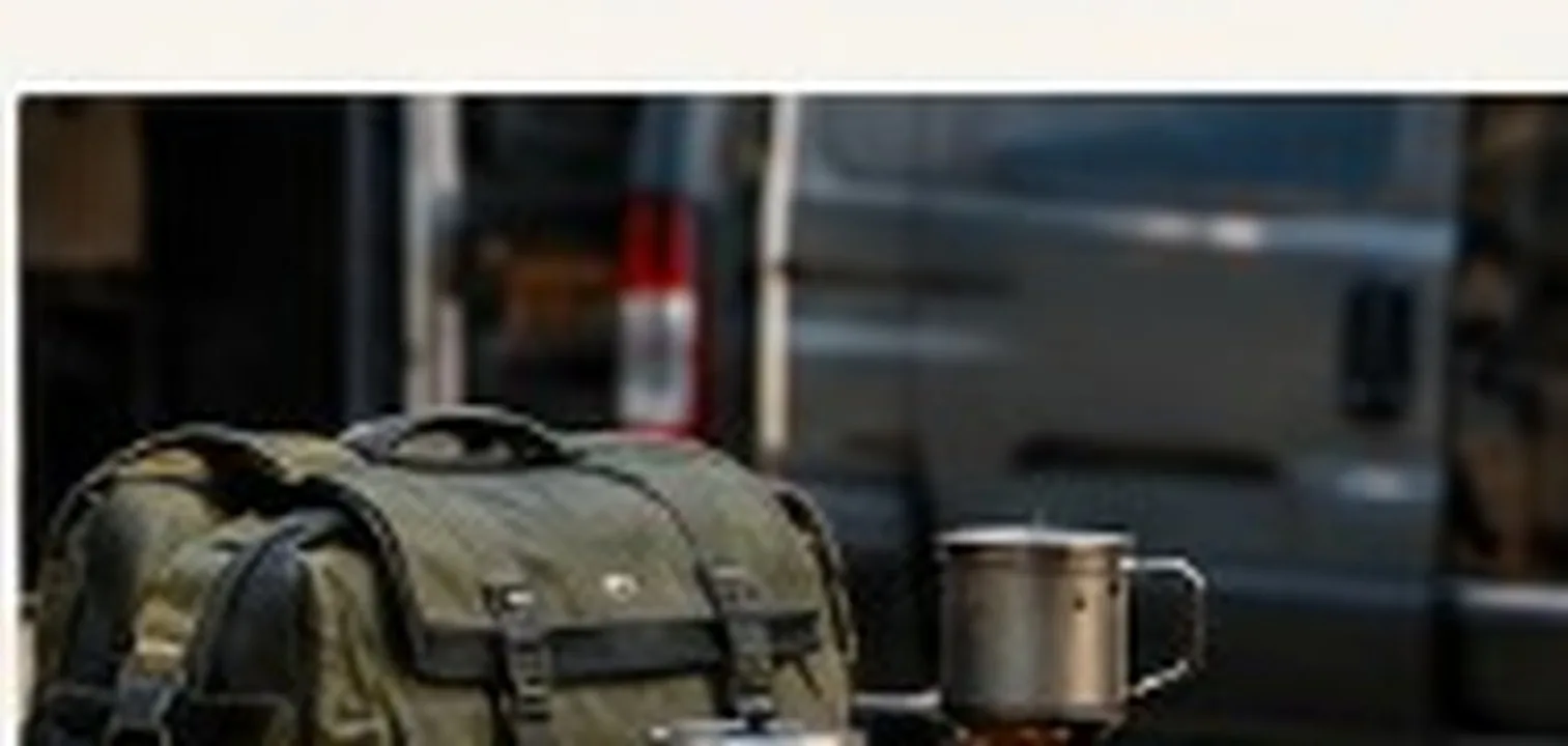 Camping gear flat-lay with pack, mug, and stove